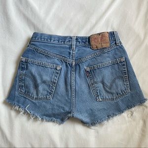 Dark washed Levi 501s cut offs